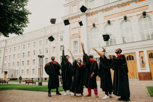 Scholarship stock image of graduates holding their caps in the air MSNZ